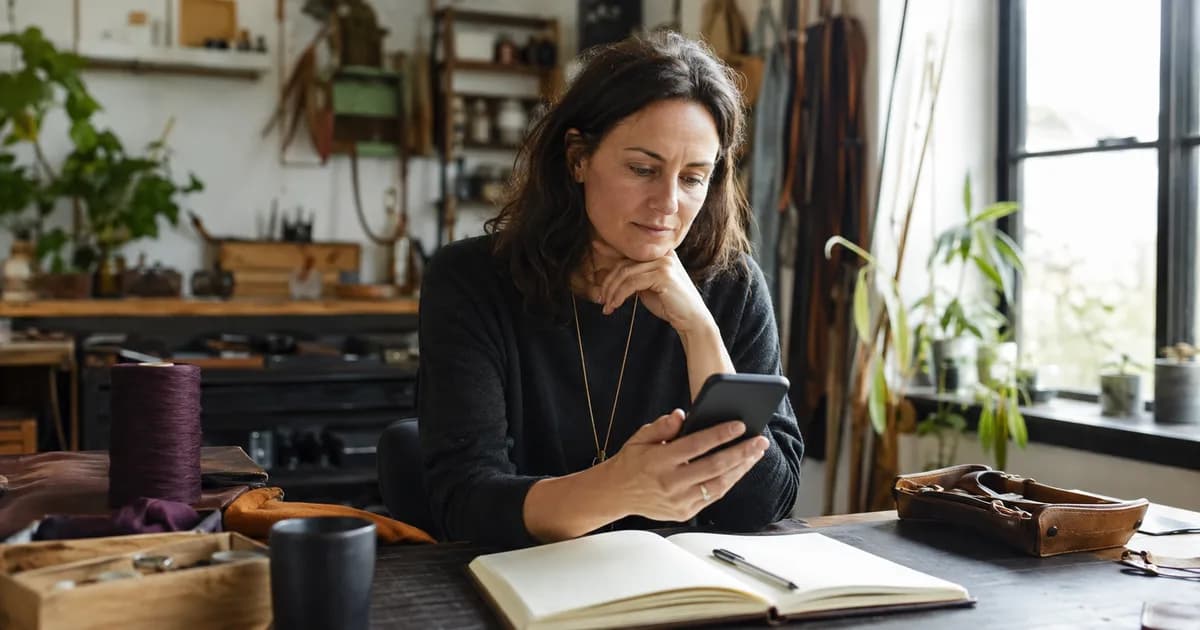 A business owner reviewing a simple contact page on a phone
